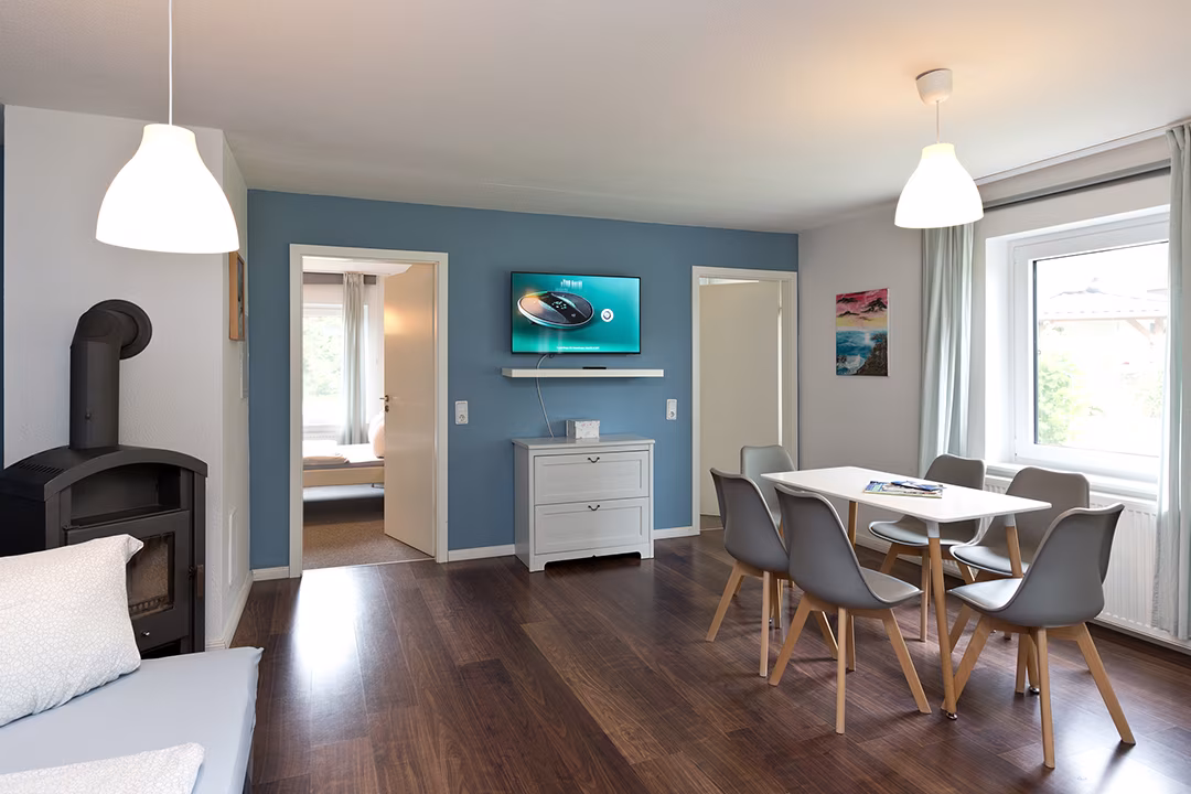 Living area with wood-burning stove and dining area in the holiday apartment in Jabel